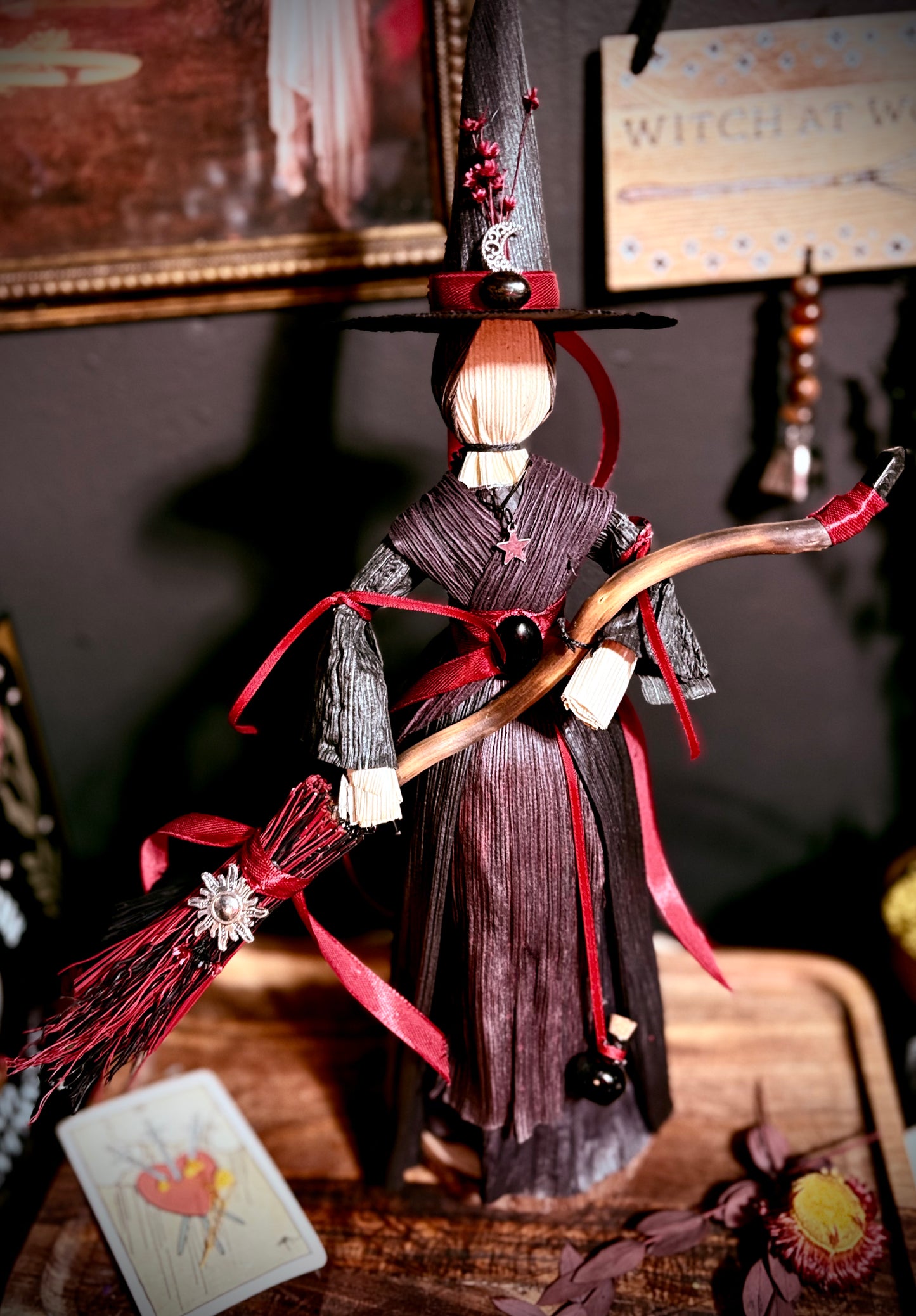 Red corn husk witch with broom