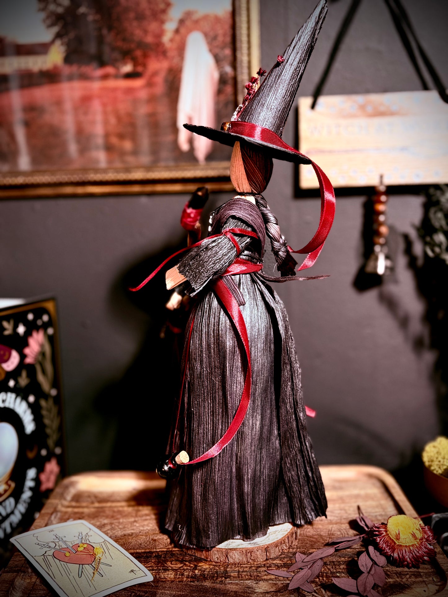 Red corn husk witch with broom